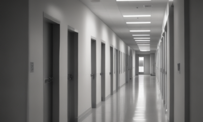 Long empty hospital corridor with fluorescent lights demonstrating architecture psychology