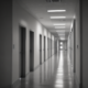 Long empty hospital corridor with fluorescent lights demonstrating architecture psychology
